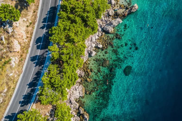 Top,View,Of,Rocky,Coastline,With,Turquoise,Water.